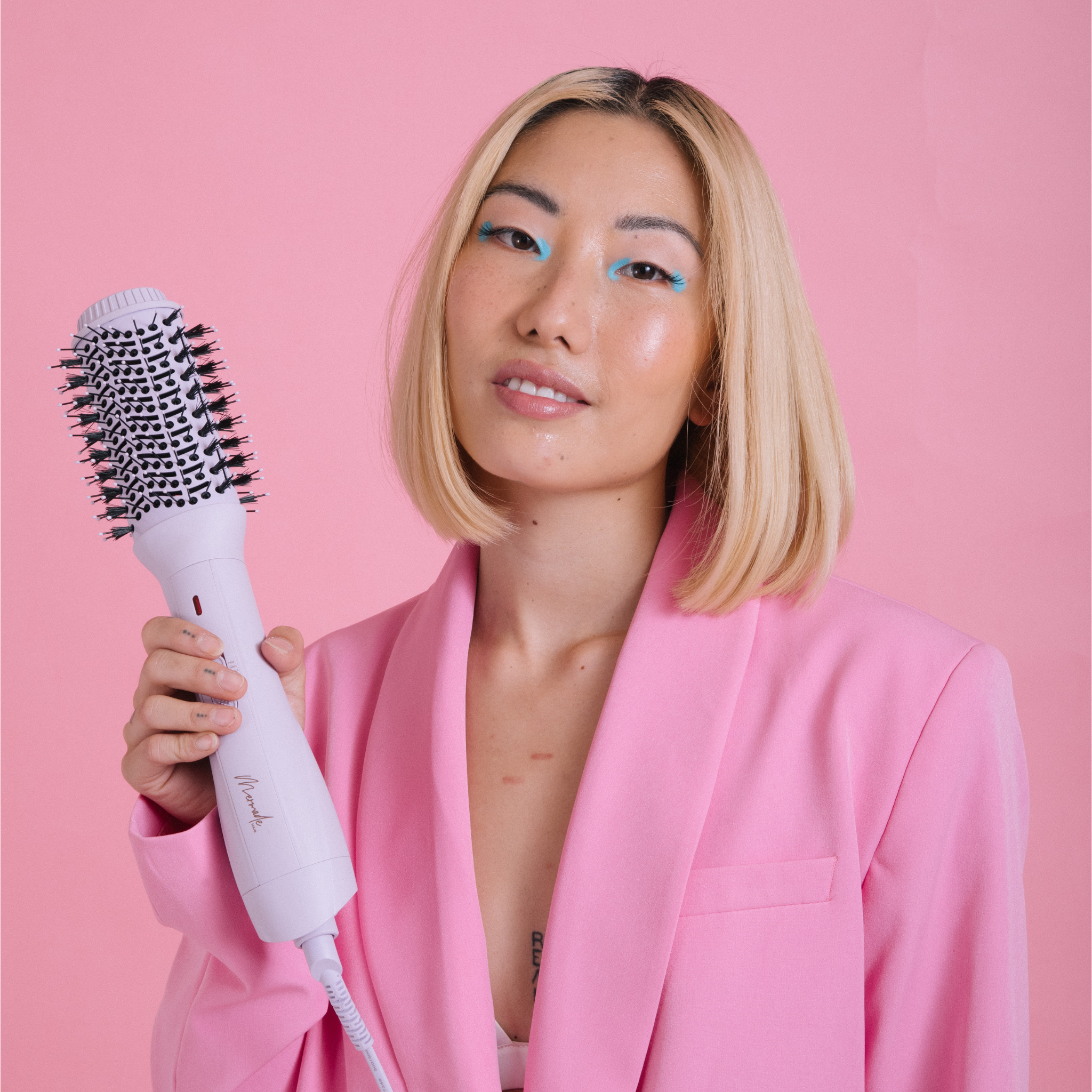 Model with short blonde hair using the Mermade Hair Blow Dry Brush - Baby Lilac 