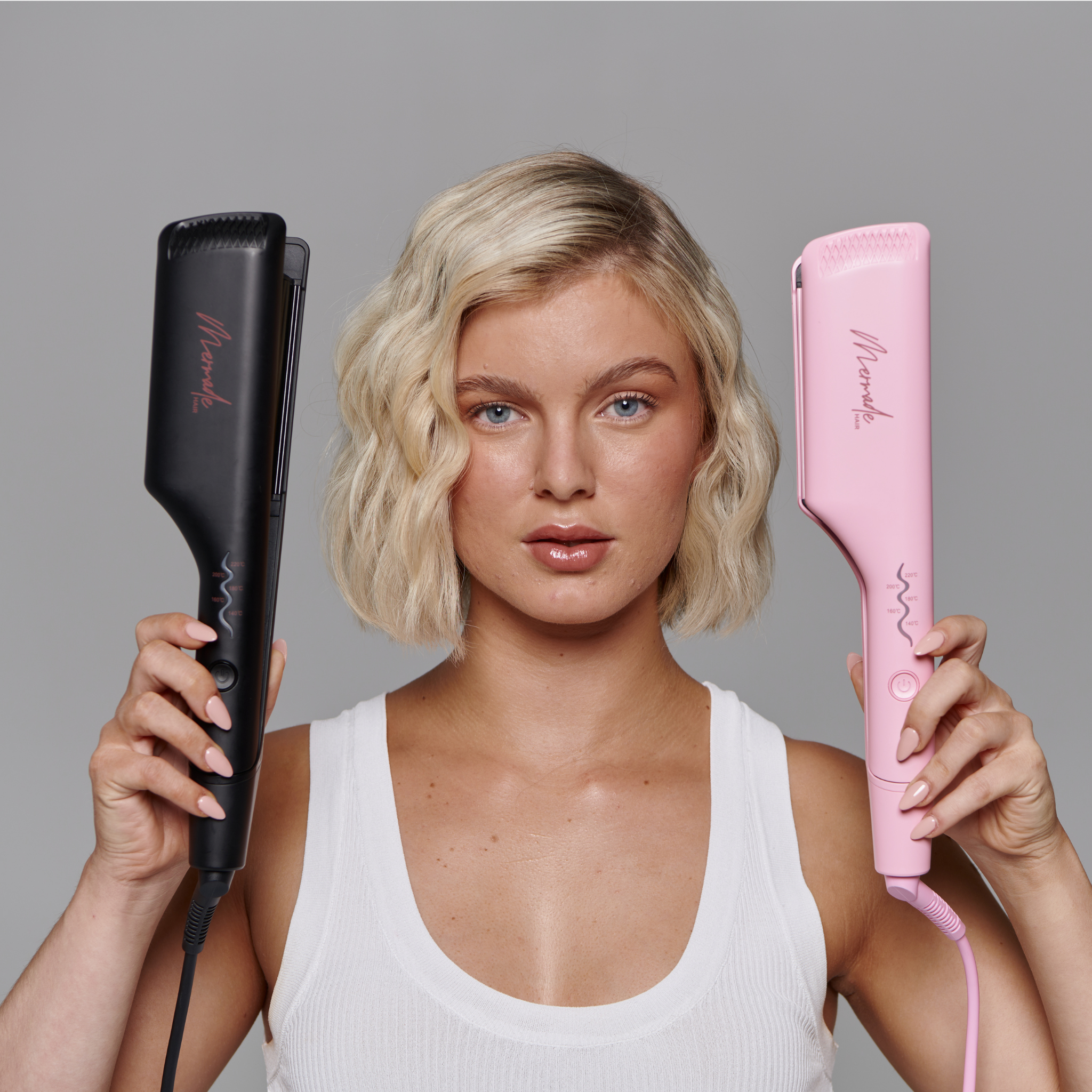 Model with short blonde hair using the Mermade Hair Double Waver - Pink